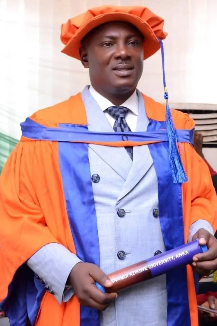 Jonathan Robinson Obuebite wearing academic regalia